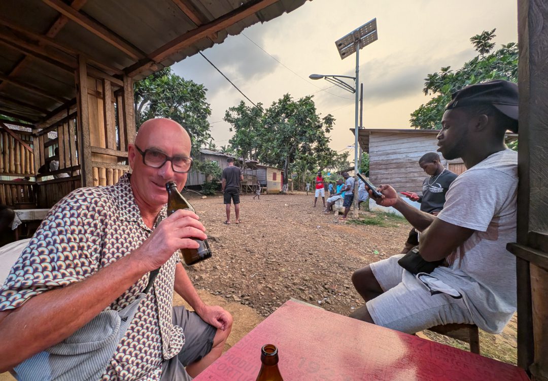 Tourist trinkt in einem afrikanischen Land Bier aus einer braunen Flasche